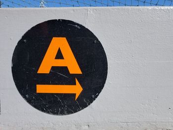 Close-up of road sign on wall