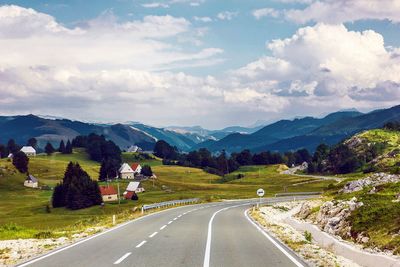 Empty road along countryside landscape