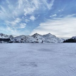 Scenic view of snow covered mountains against sky