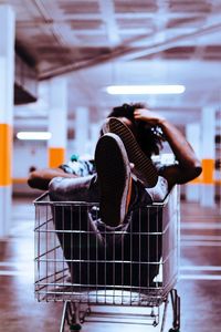 Man sitting in shopping cart