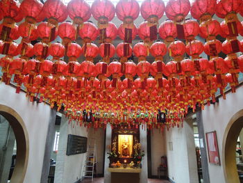 Low angle view of illuminated lanterns hanging in building