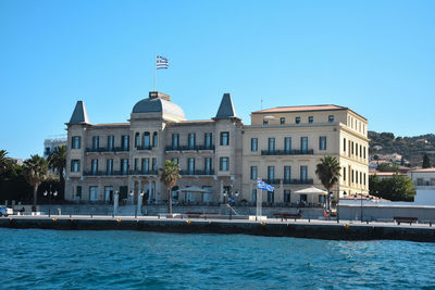 Buildings by sea against clear sky island greece