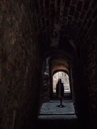 Full length of woman standing in tunnel