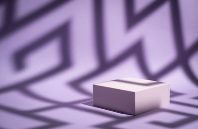 Close-up of cube over purple background