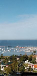High angle view of buildings by sea against sky