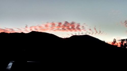 Silhouette mountains against sky during sunset