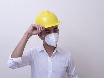 Low angle view of man working against white background