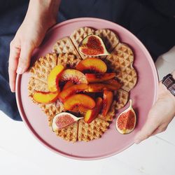 High angle view of hand holding bowl