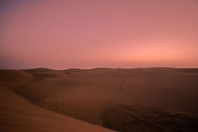 Scenic view of desert against sky during sunset