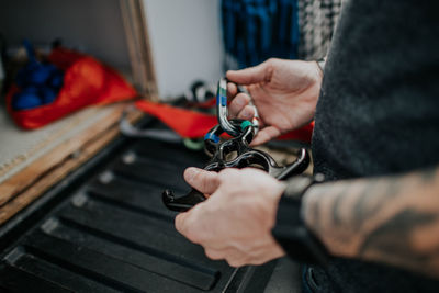 Man holding rappel descender for rock climbing