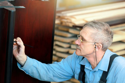 Portrait of man holding eyeglasses