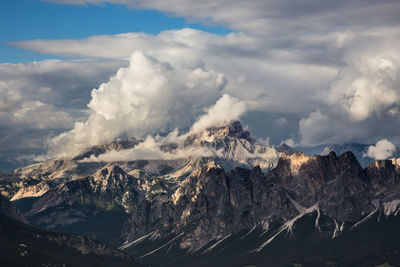 Scenic view of dolomites against cloudy sky