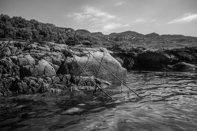 Rock formations by sea against sky