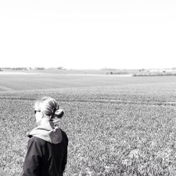 Woman standing on grassy field