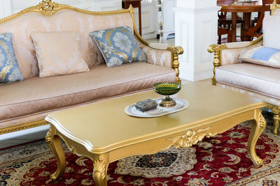 Detail image of pillows on an antique luxury sofa, living room interior design and decoration