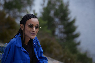 Portrait of smiling woman relaxing in nature