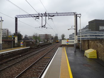 Train at railroad station against sky