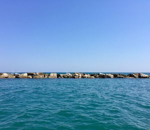 Scenic view of sea against clear blue sky