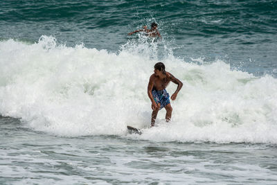 Full length of man surfing in sea