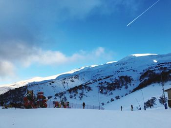 View of snowcapped mountain against blue sky