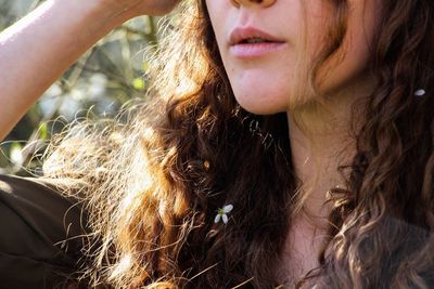 Close-up of teenage girl with brown hair outdoors