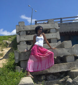 Rear view of woman standing against sky