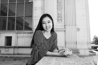 Portrait of smiling woman sitting outdoors