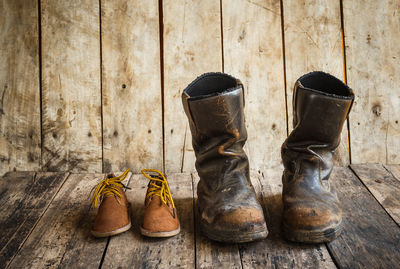 Close-up of old shoes on wooden table