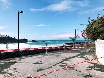 Street by sea against sky