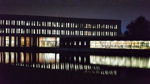 Illuminated building against sky at night