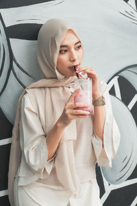 Midsection of a woman drinking glass