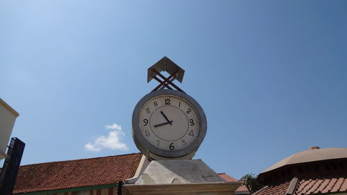 Low angle view of clock tower against sky