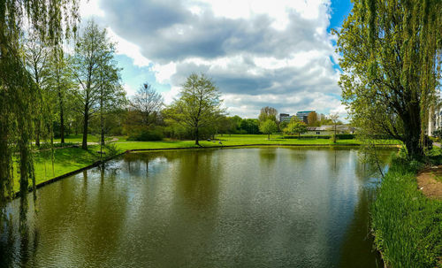 Scenic view of river against cloudy sky