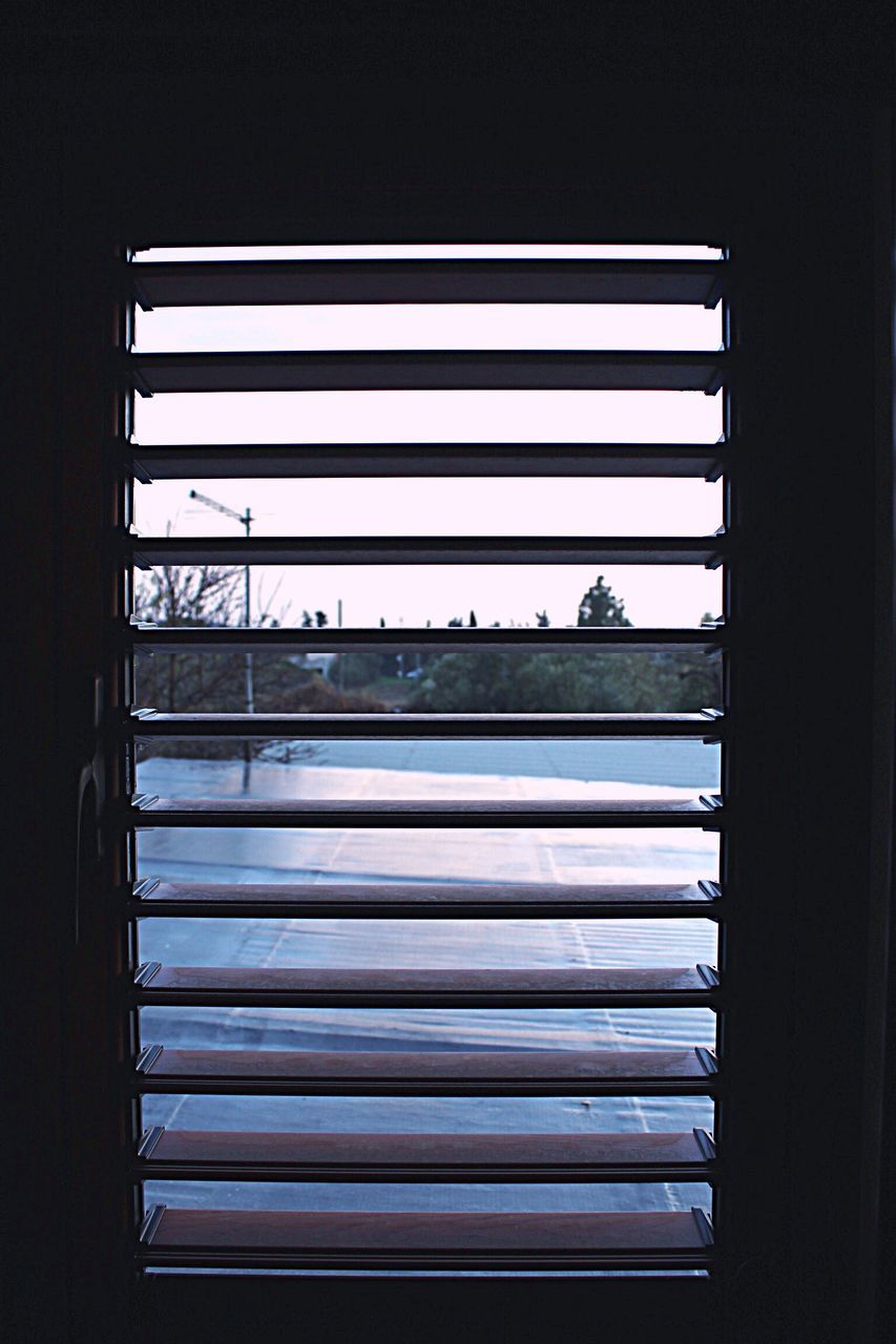 CLOSED WINDOW AGAINST SKY SEEN THROUGH HOME