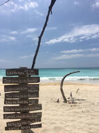 Lifeguard hut on beach against sky