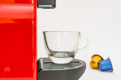 Close-up of wineglass on table against white background