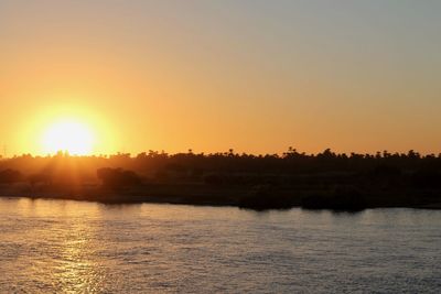 Scenic view of river against sky during sunset