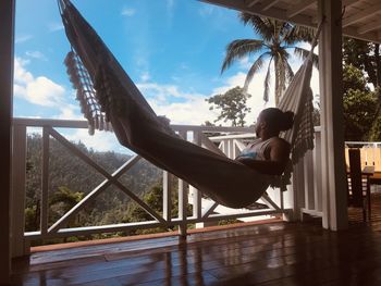 Side view of man lying in a hammock