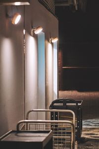 Empty chairs and table against wall