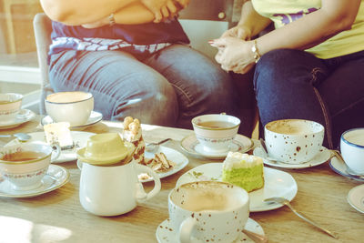 Close-up of people sitting on table