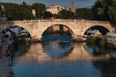 Bridge over river with buildings in background