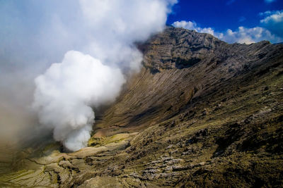 Smoke emitting from volcanic mountain