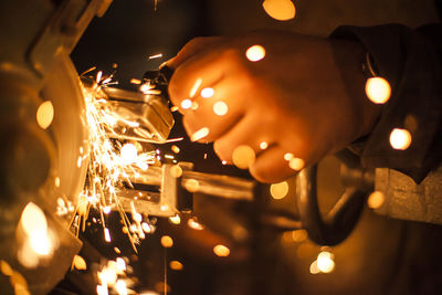 Cropped hand of worker grinding