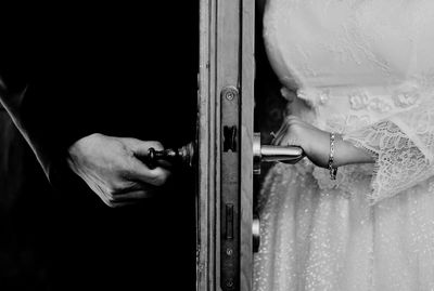 Close-up of hand holding metal door