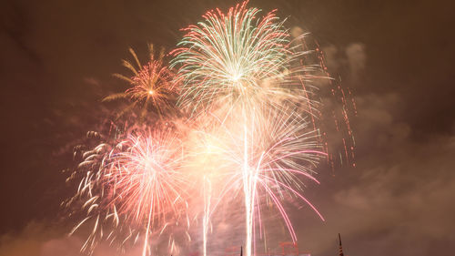 Low angle view of firework display at night