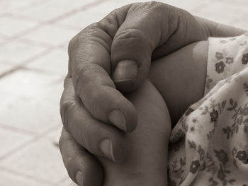 Midsection of woman with baby hands