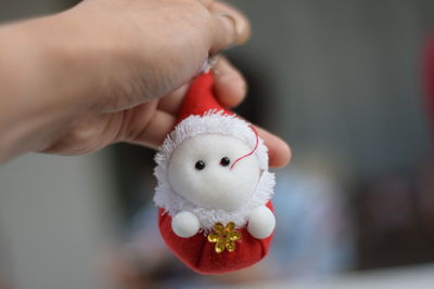 Cropped hand holding christmas decoration