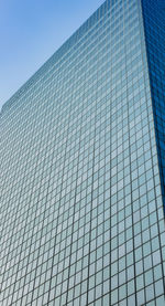 Low angle view of modern building against clear blue sky