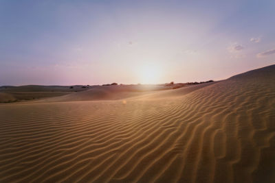 Scenic view of desert against sky during sunset