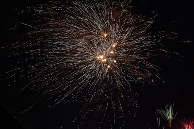 Low angle view of firework display at night